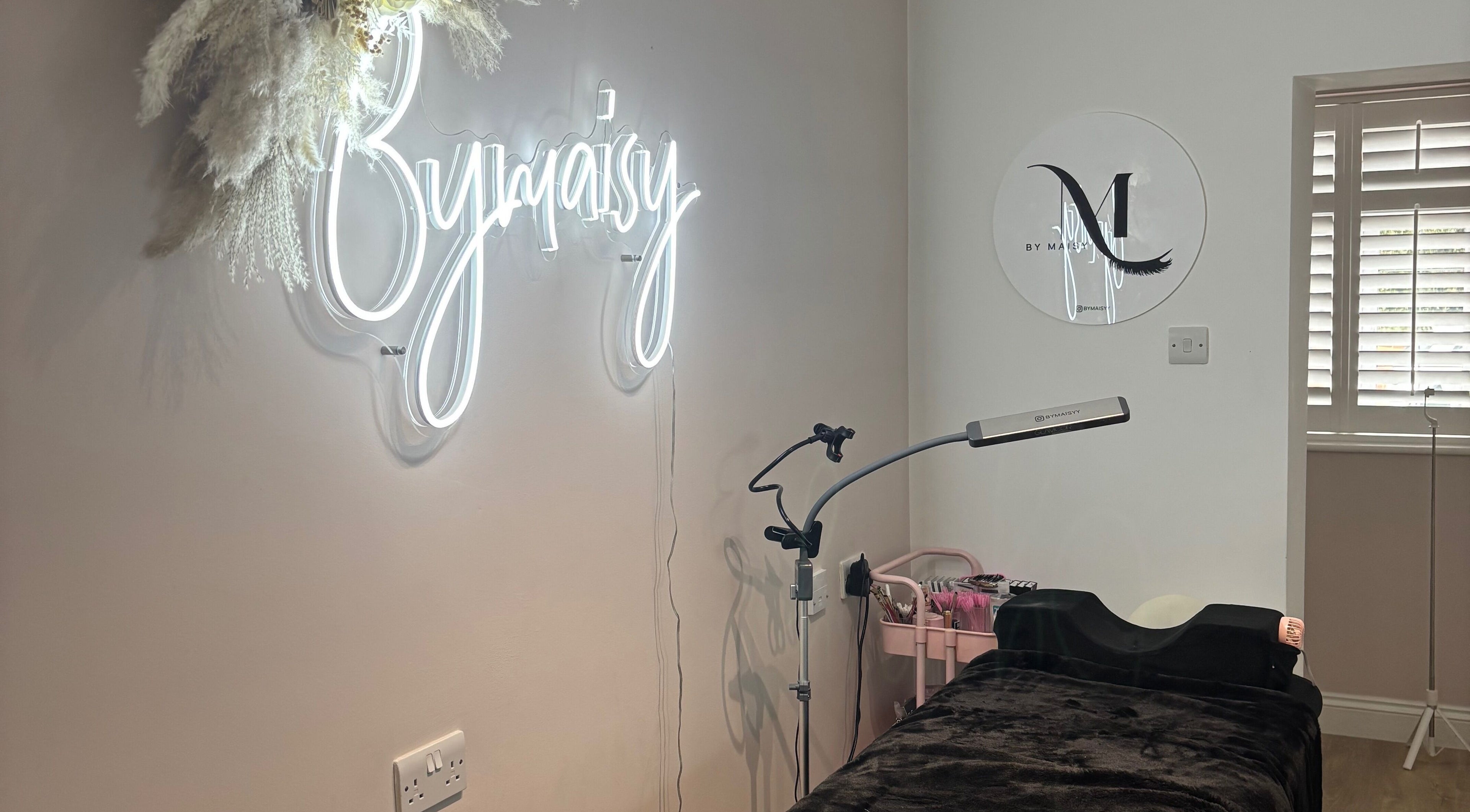 ByMaisy beauty room with neon sign and treatment bed in Bexleyheath, England, GB.