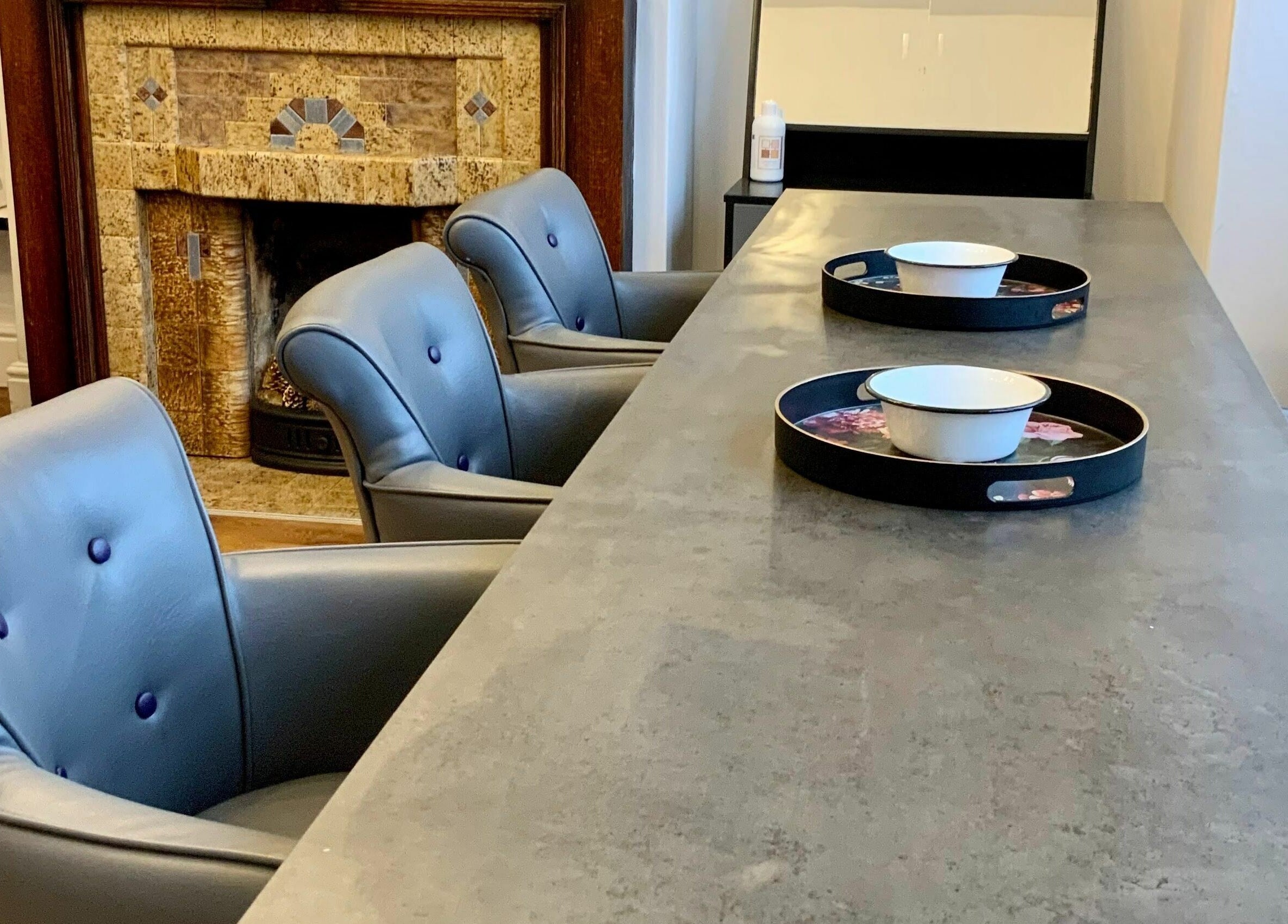 Elegant lounge area in The Sunshine Store, Radcliffe on Trent, England with plush chairs and intricate fireplace.
