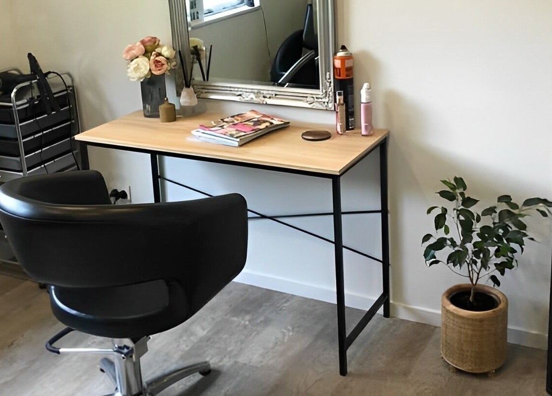 Cozy styling area at Beautify hair by Dee Charles, Nelson, NZ with chair, desk, and stylish décor.