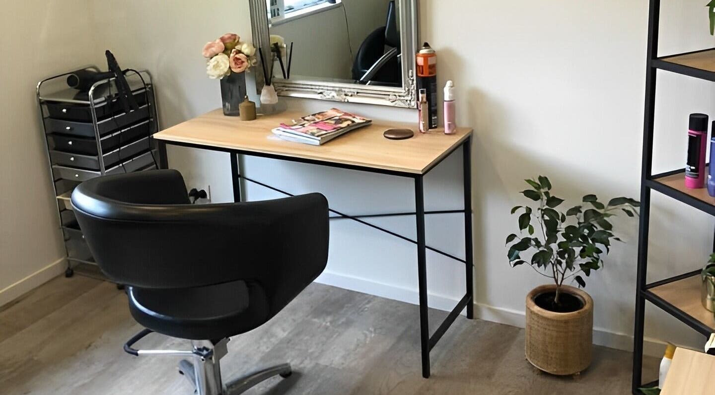 Cozy styling area at Beautify hair by Dee Charles, Nelson, NZ with chair, desk, and stylish décor.