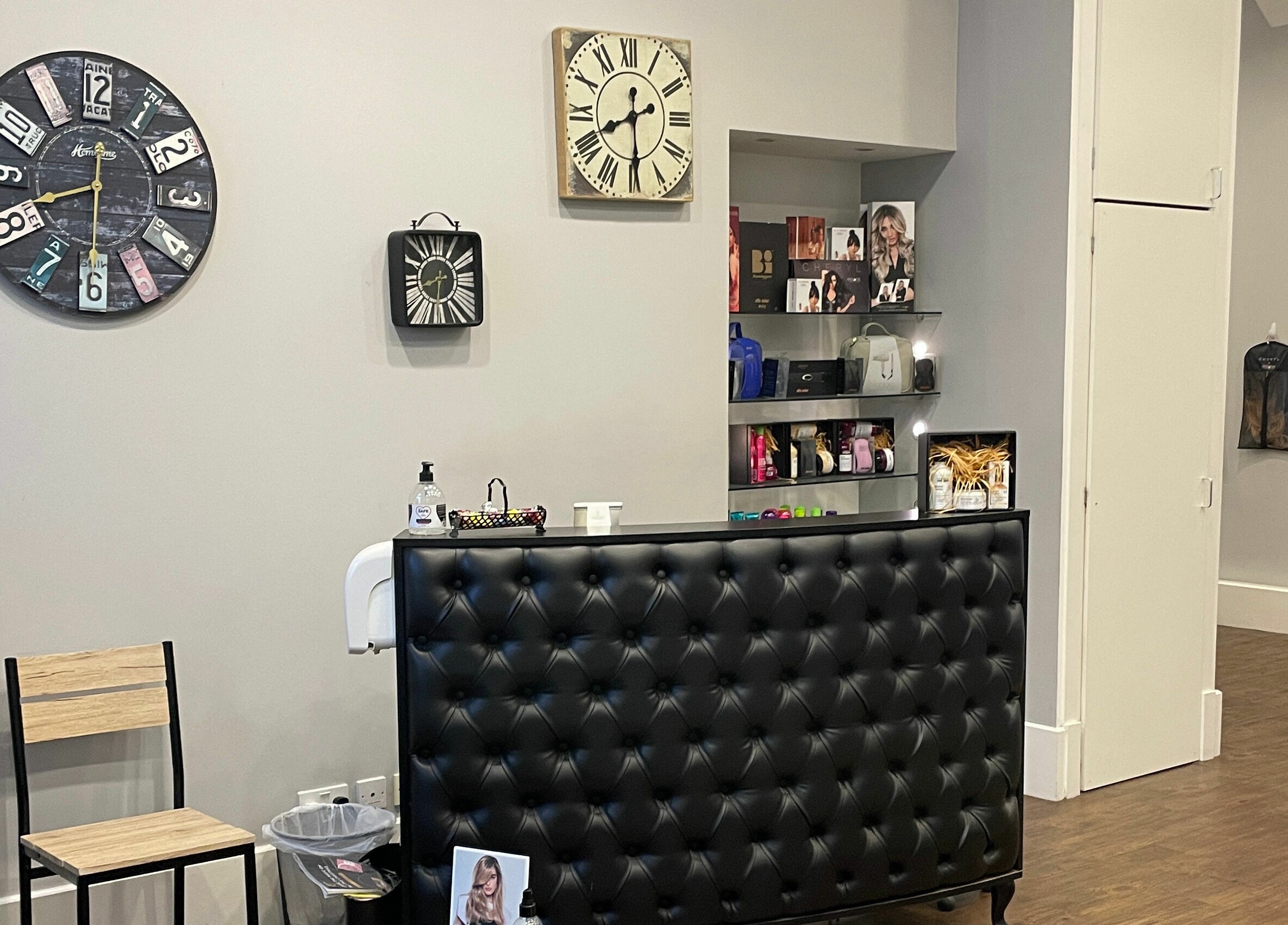Stylish reception at House of Hair in Guernsey, Saint Peter Port, GG with clocks and shelves.