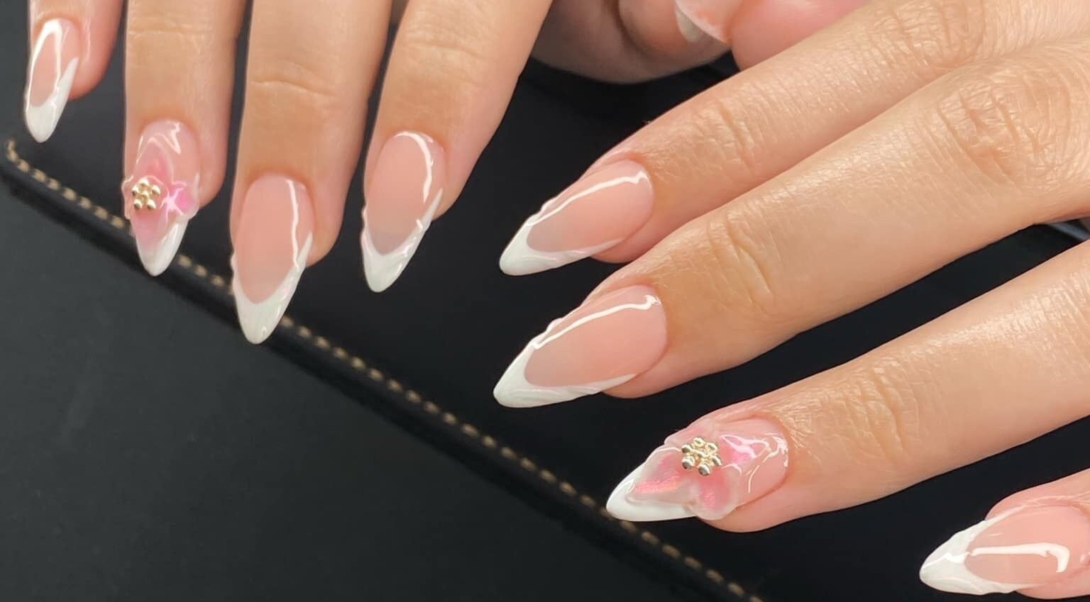 Close-up of elegant French manicured nails at Evermore Lux, Park Ridge, Queensland, AU.