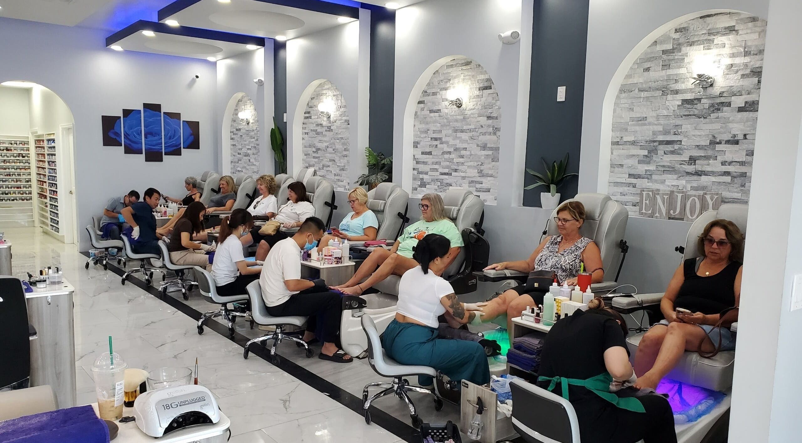 Guests enjoying pedicures at Ava Nails, The Villages, Florida, US in a modern, serene setting.