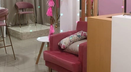 Interior de Alejandra Bunny Studio con sillón rosa y decoración vibrante en Lázaro Cárdenas, Michoacán, MX.