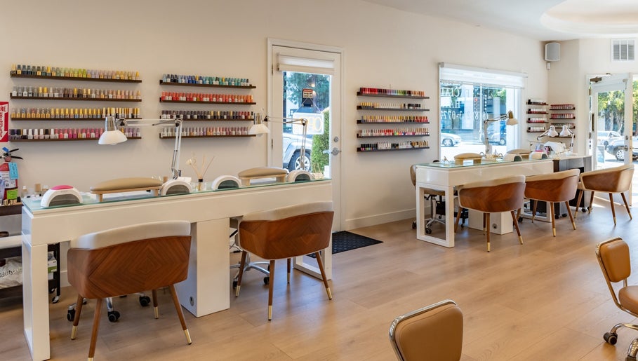 Interior of Powder Beauty Salon, Burbank, California, US, featuring stylish nail stations and colorful polish displays.