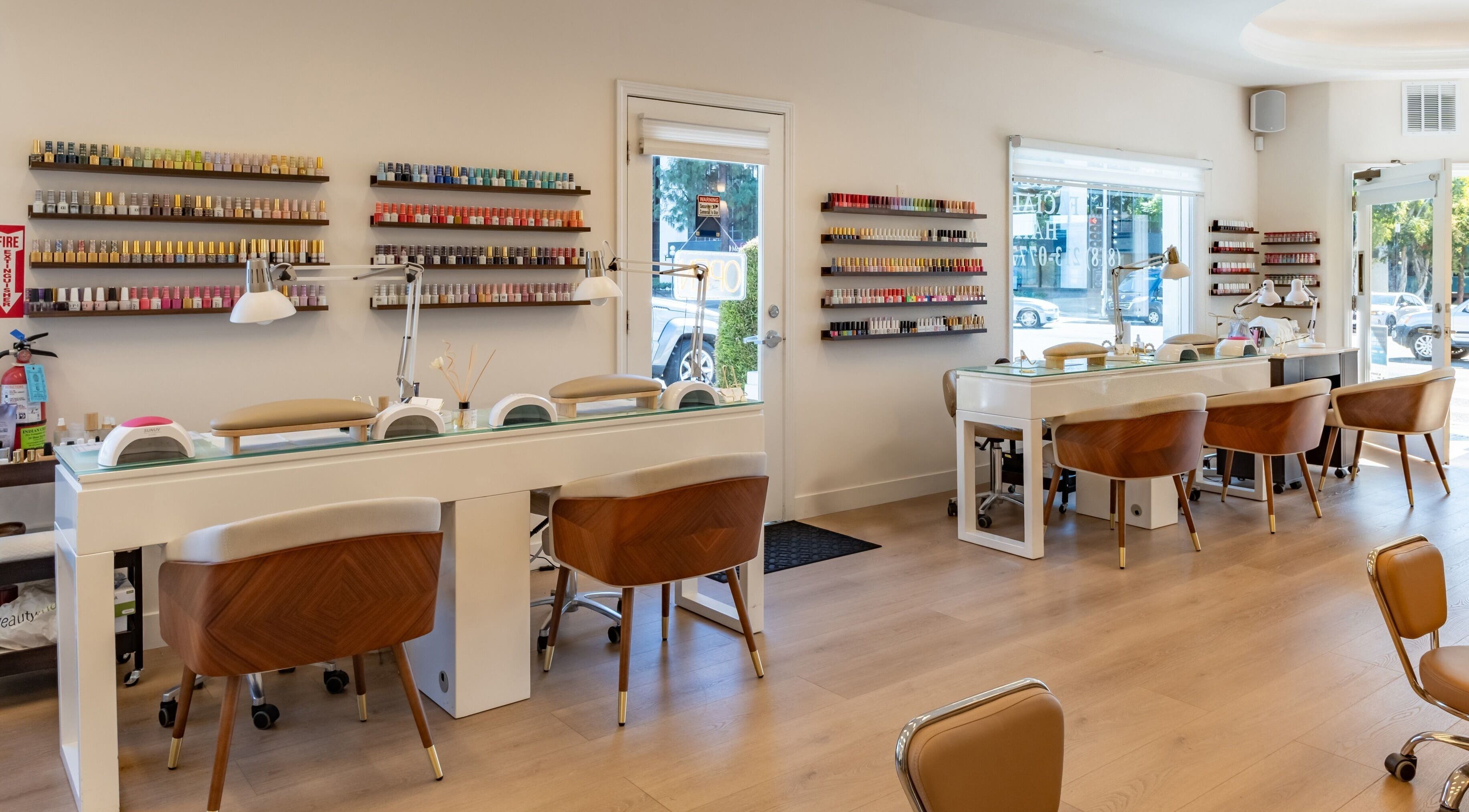 Interior of Powder Beauty Salon, Burbank, California, US, featuring stylish nail stations and colorful polish displays.