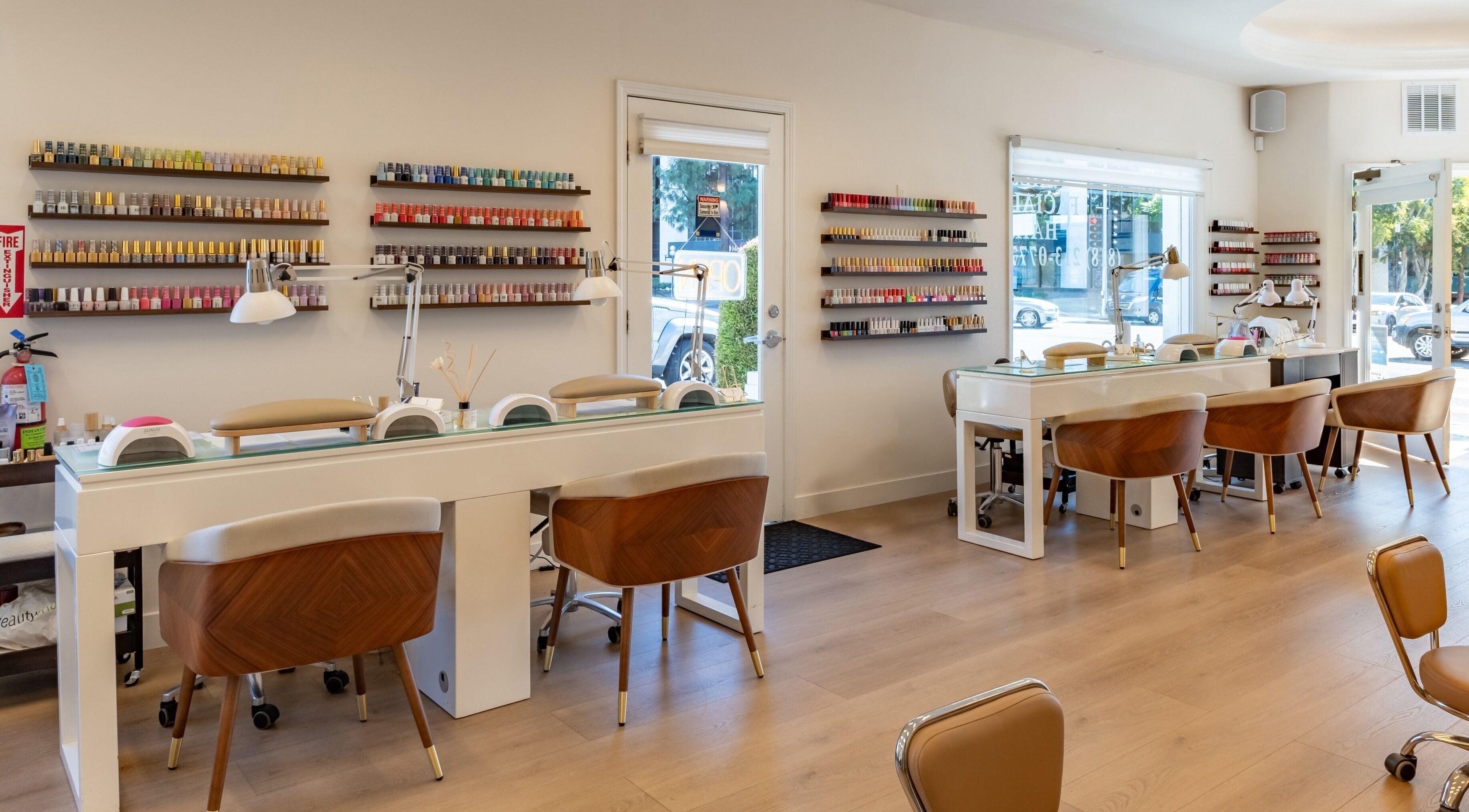 Interior of Powder Beauty Salon, Burbank, California, US, featuring stylish nail stations and colorful polish displays.