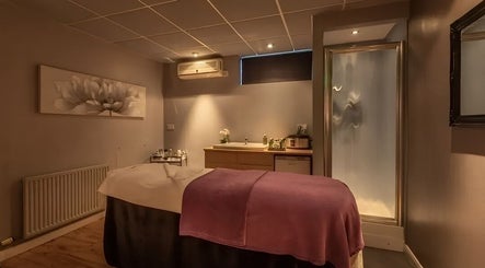 Tranquil massage room at Shass Therapy Massage in Matson, England, GB featuring ambient lighting.