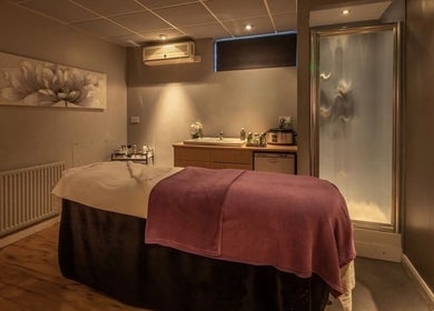 Relaxing treatment room at Shass Therapy @ Gloucester Robinswood Hotel, Gloucester, England, GB with plush table.