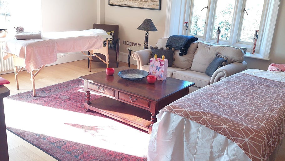 Welcoming massage room at Shass Therapy Mobile Massage in Gloucester, England, GB with cozy sofa and massage table.