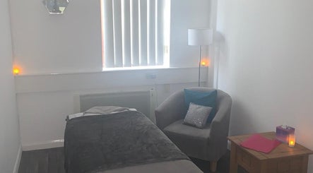 Cozy massage room at Shass Therapy Mobile Massage, Gloucester, England, GB, with soft lighting and comfortable decor.