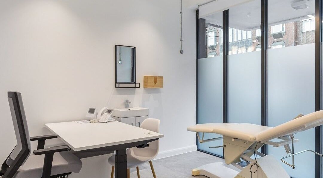 Modern treatment room at Emily Jane at The MediClinic, London, England, GB with sleek chairs and examination table.