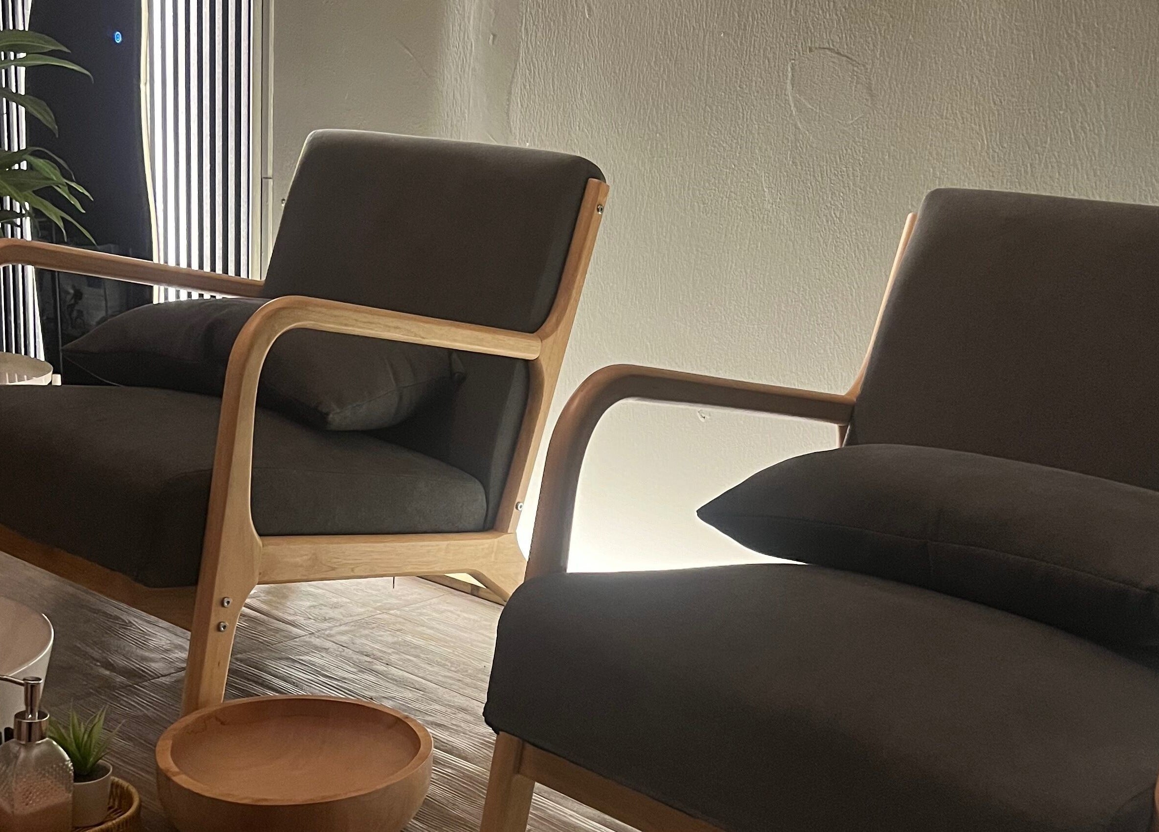 Relaxing lounge area at NoonaLash Laman Areca, Nilai, Negeri Sembilan, MY with plush chairs and warm lighting.