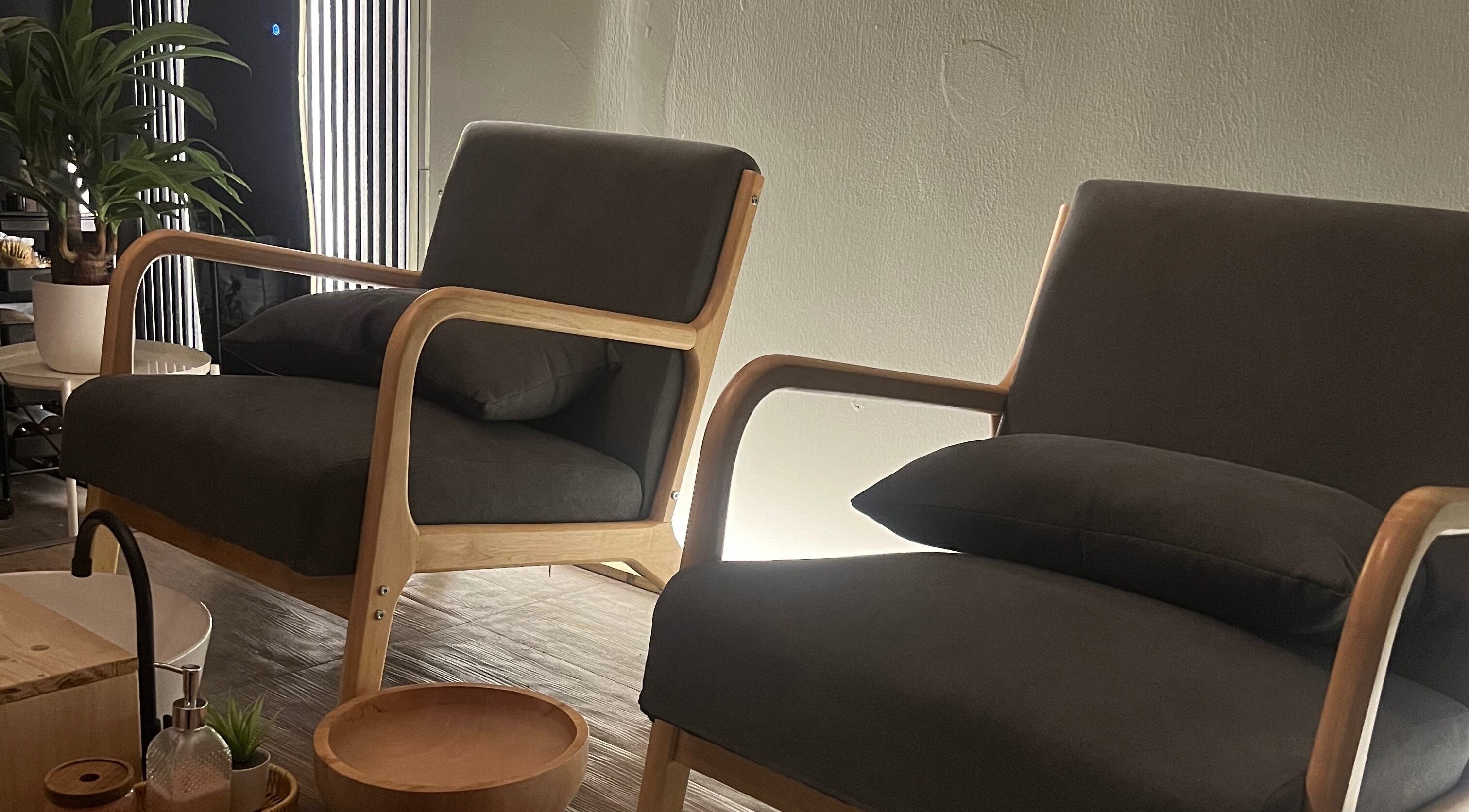 Relaxing lounge area at NoonaLash Laman Areca, Nilai, Negeri Sembilan, MY with plush chairs and warm lighting.