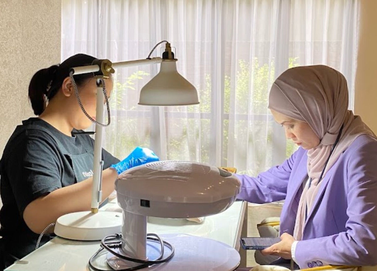 Customer receiving professional nail treatment at N by Noonalash - Streetmall @ Cyberjaya, Cyberjaya, Selangor, MY.