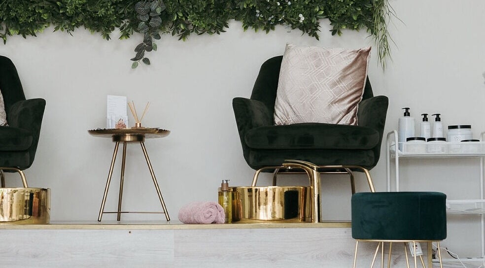 Luxurious seating at Narelle Beauty, Castleford, England, GB with plush chair and golden decor.