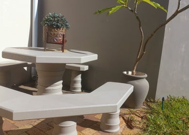 Outdoor seating at Vanilla Touch Studios - Edgemead Cape Town, Cape Town, Western Cape, ZA with table and plant.