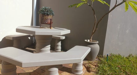 Outdoor seating at Vanilla Touch Studios - Edgemead Cape Town, Cape Town, Western Cape, ZA with table and plant.