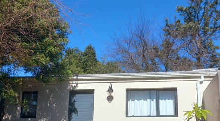 Exterior view of Vanilla Touch Studios - Edgemead Cape Town, surrounded by lush trees in Cape Town, Western Cape, ZA.