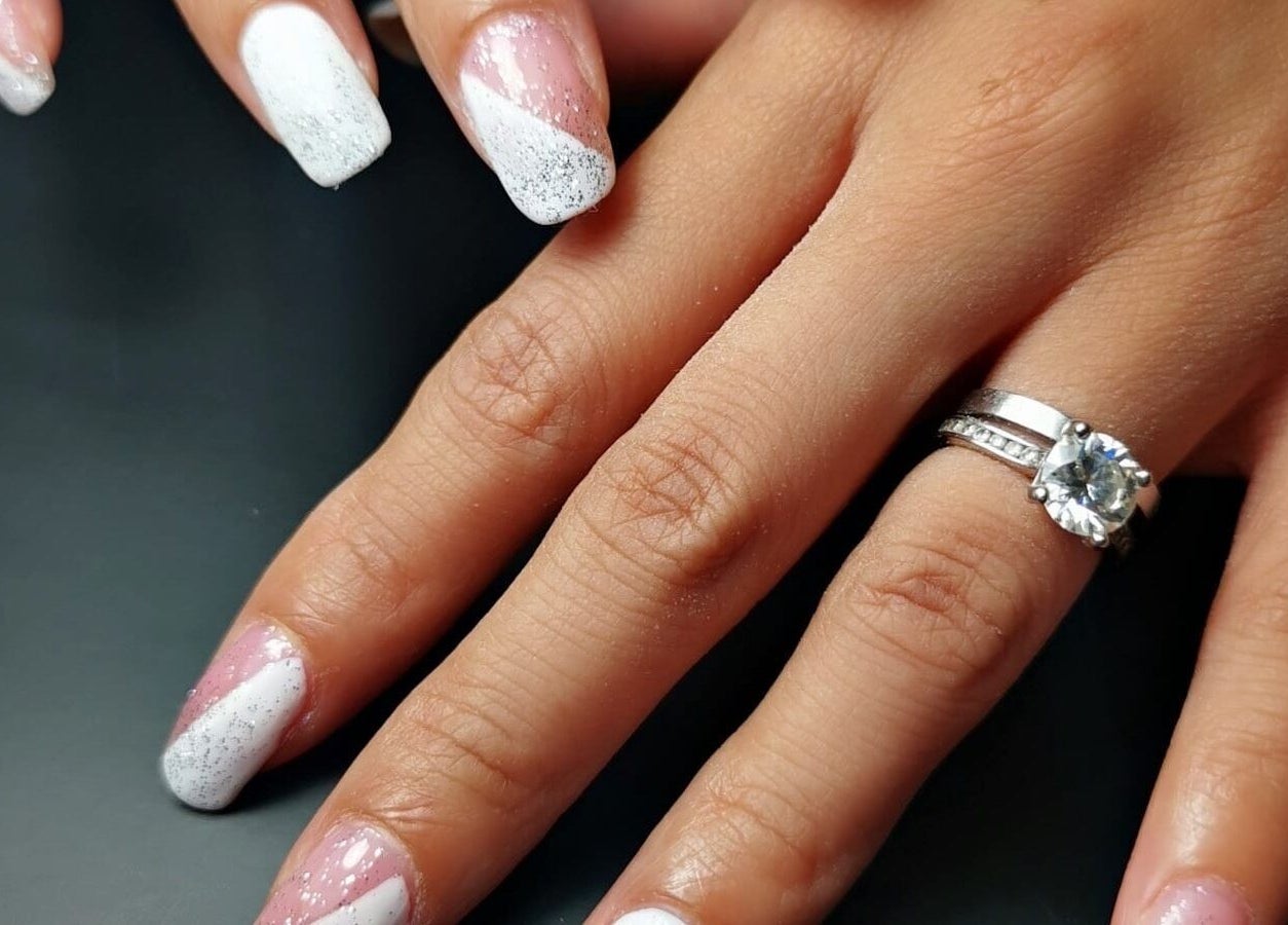 Manicured nails with white and pink design at Hands of Buddha, Sale, England, GB.