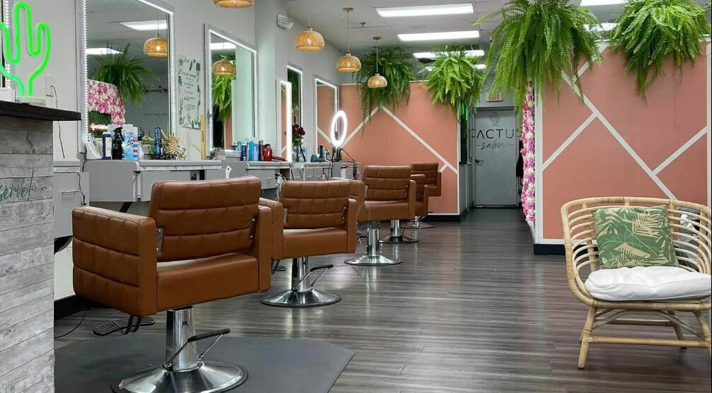 Modern interior of Cactus Salon in Addison, Texas, US with plush seating and vibrant decor.