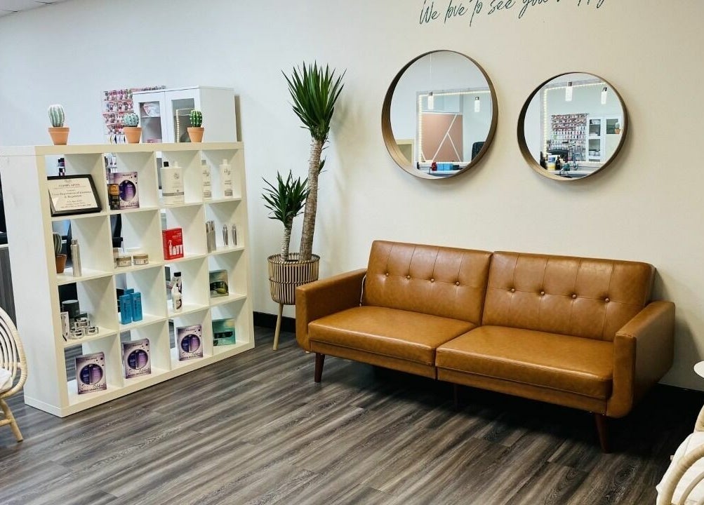 Stylish seating area at Cactus Salon in Addison, Texas, US showcasing modern decor and beauty products.