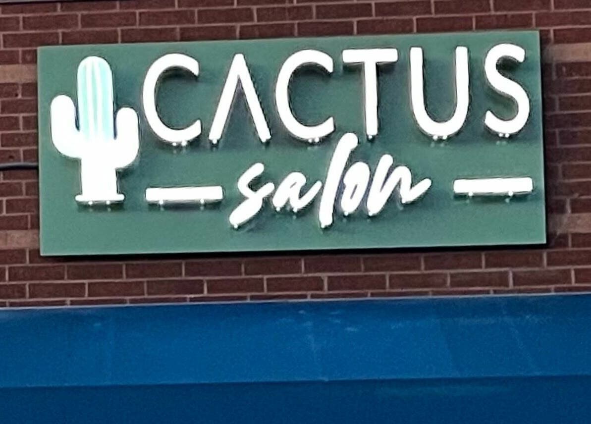 Cactus Salon signage glowing in neon, located in Addison, Texas, US.