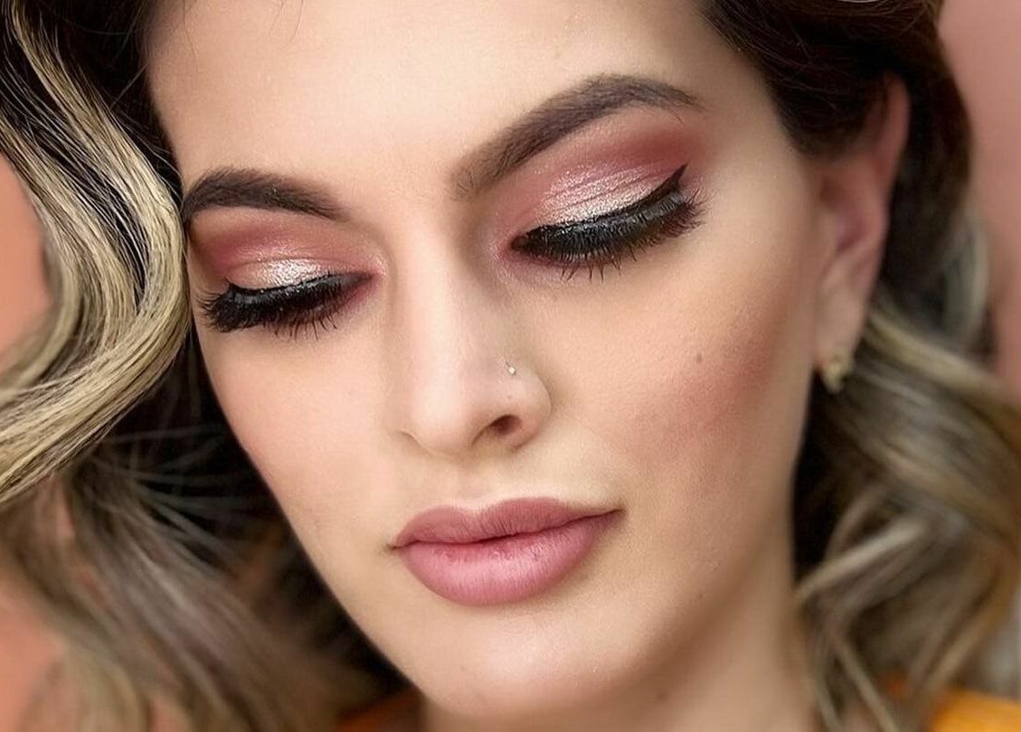 Elegant makeup look at Cactus Salon in Addison, Texas, US, showcasing shimmering eyeshadow and styled curls.
