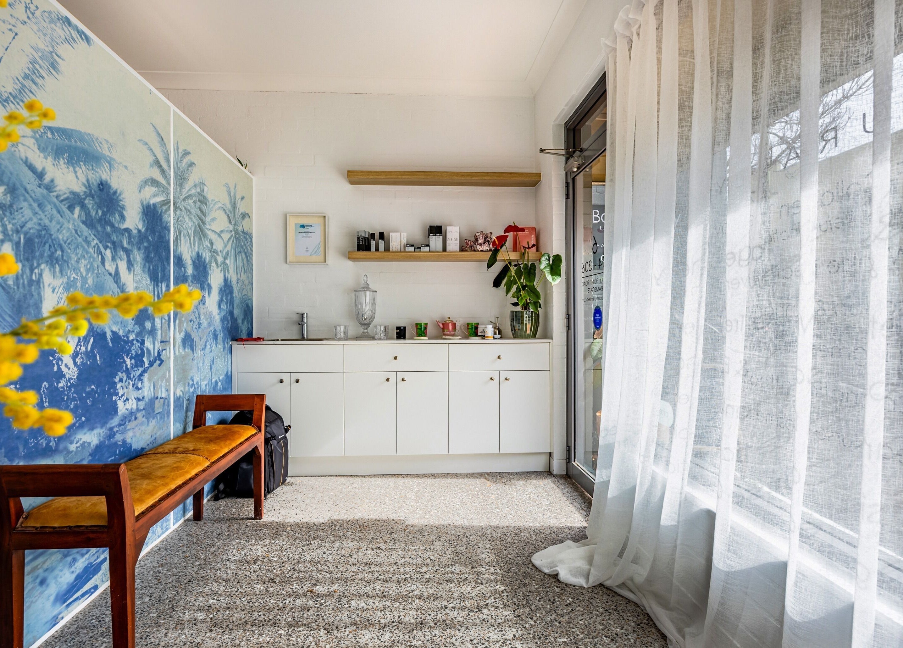 Inviting entrance at Bare Beauty Clinic Sydney, NSW, AU with light decor and lush plant accents.