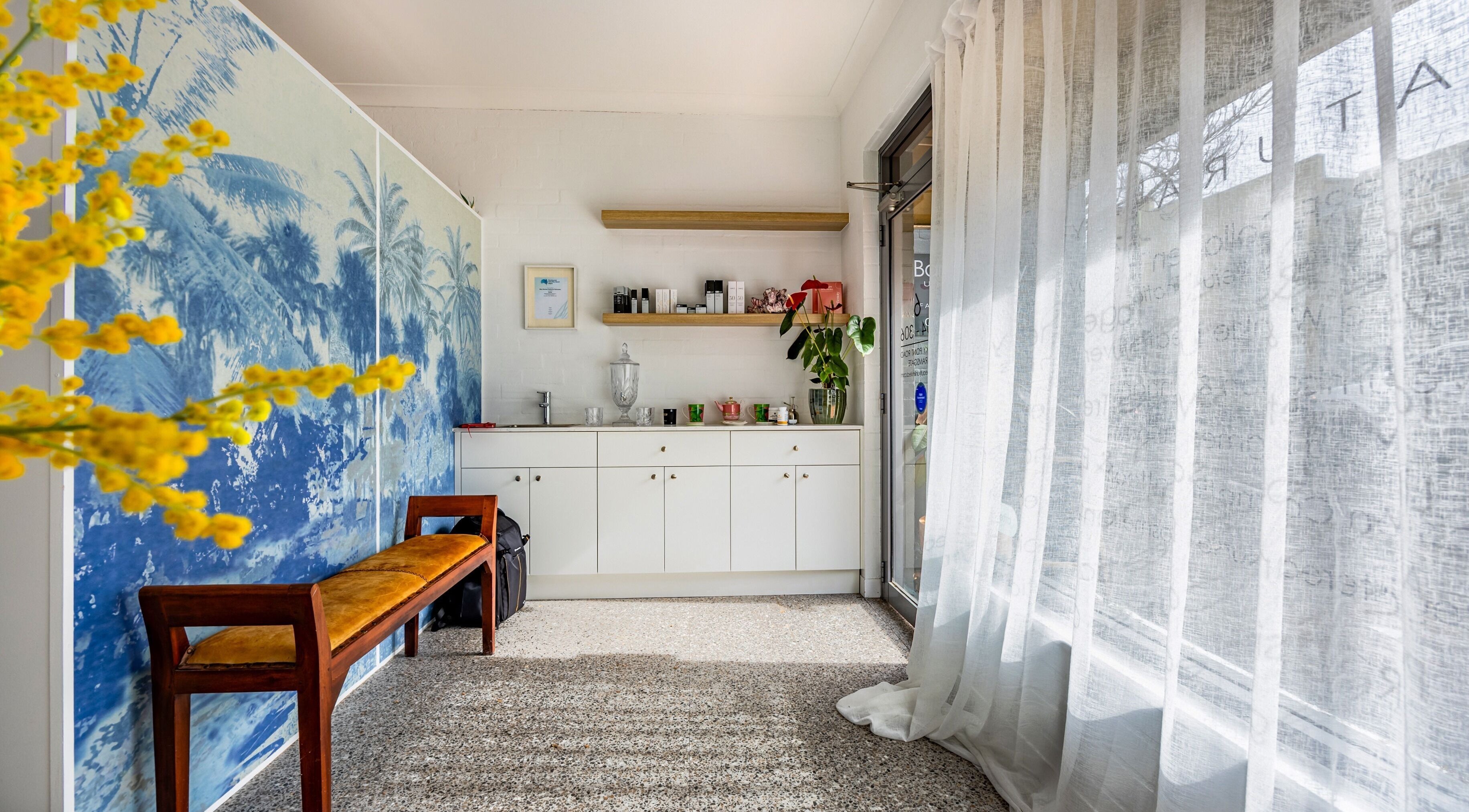Inviting entrance at Bare Beauty Clinic Sydney, NSW, AU with light decor and lush plant accents.