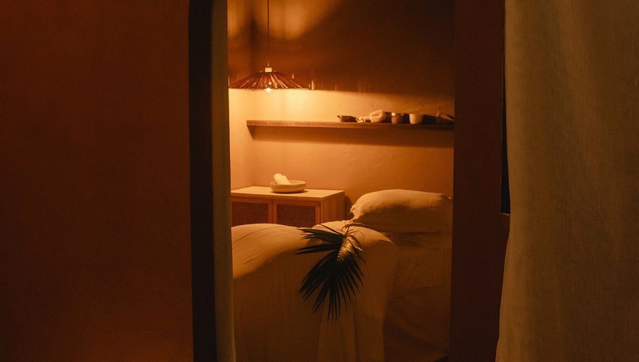 Cozy massage room at Kondōu, Kincumber, New South Wales, AU, with warm lighting and serene ambiance.