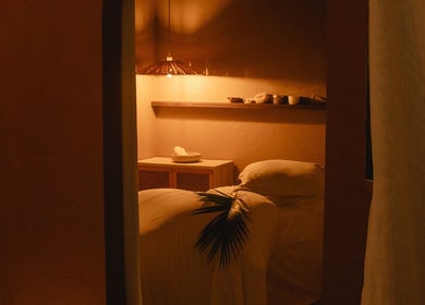 Cozy massage room at Kondōu, Kincumber, New South Wales, AU, with warm lighting and serene ambiance.