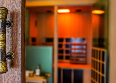 Intricately designed door handle at Kondōu in Kincumber, New South Wales, AU leading to a warm-lit room.