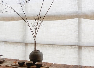 Elegant rustic decor at Kondōu, Kincumber, New South Wales, AU with pottery and dried branches on a wooden table.