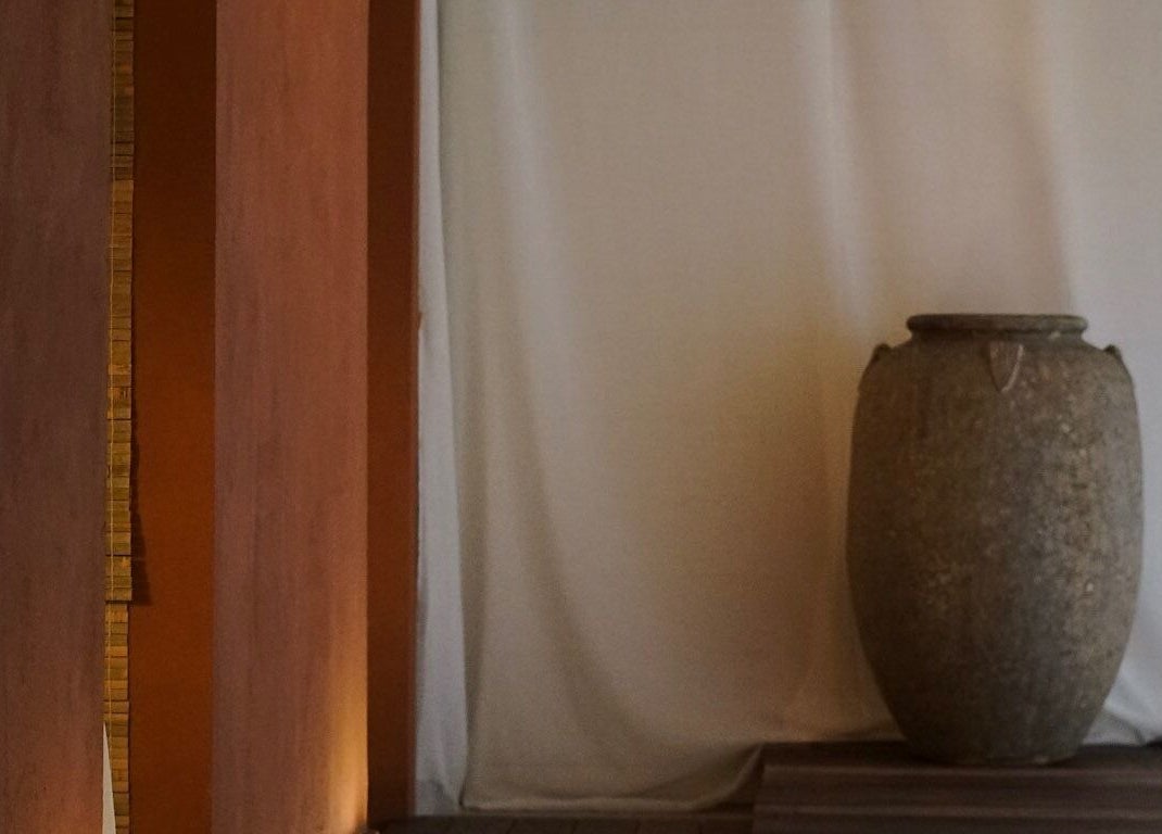 Elegant stone vase at Kondōu spa in Kincumber, New South Wales, AU, offering a tranquil ambiance.