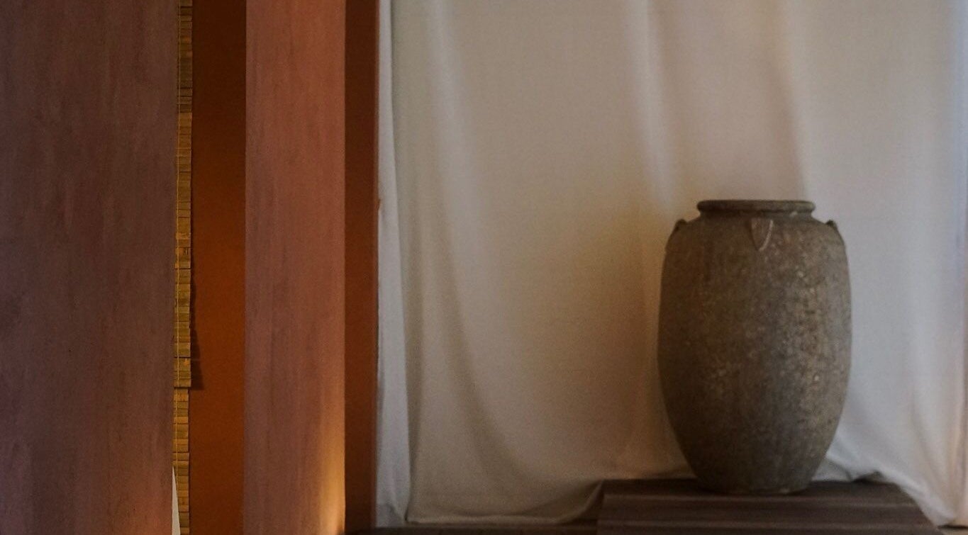 Elegant stone vase at Kondōu spa in Kincumber, New South Wales, AU, offering a tranquil ambiance.