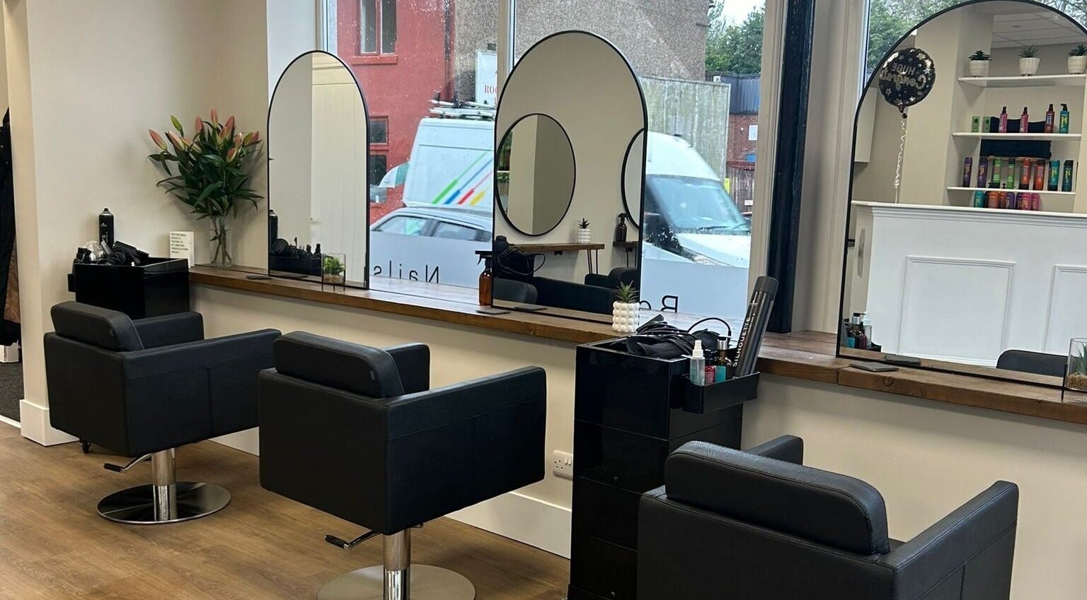 Interior of Escape House of Hair & Beauty featuring chic salon chairs in Hednesford, England, GB.