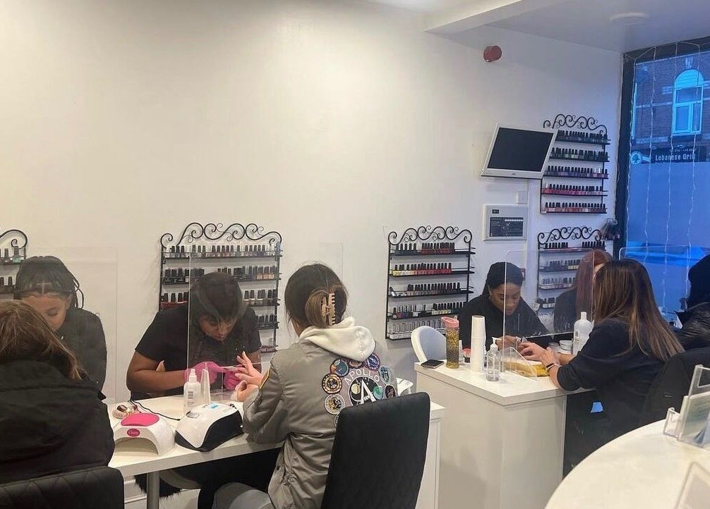 Hers & Sirs nail salon in Manchester, England, GB, bustling with clients enjoying manicures.