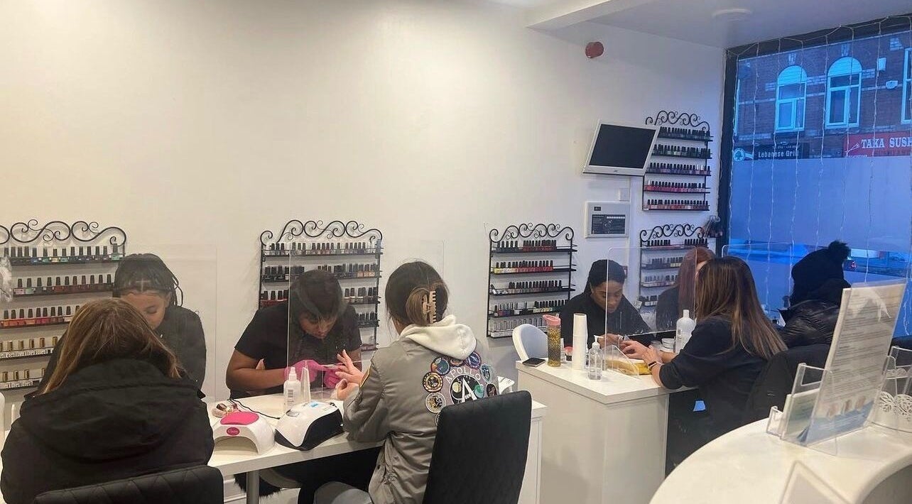 Hers & Sirs nail salon in Manchester, England, GB, bustling with clients enjoying manicures.