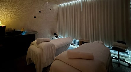 Tranquil massage room at OCEAN Day Spa in Surfers Paradise, Queensland, AU, featuring two cozy treatment beds.