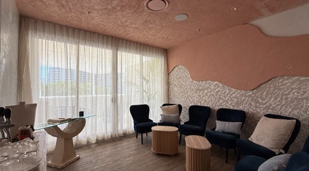 Relaxing lounge area at OCEAN Day Spa, Surfers Paradise, Queensland, AU with elegant seating and soft lighting.
