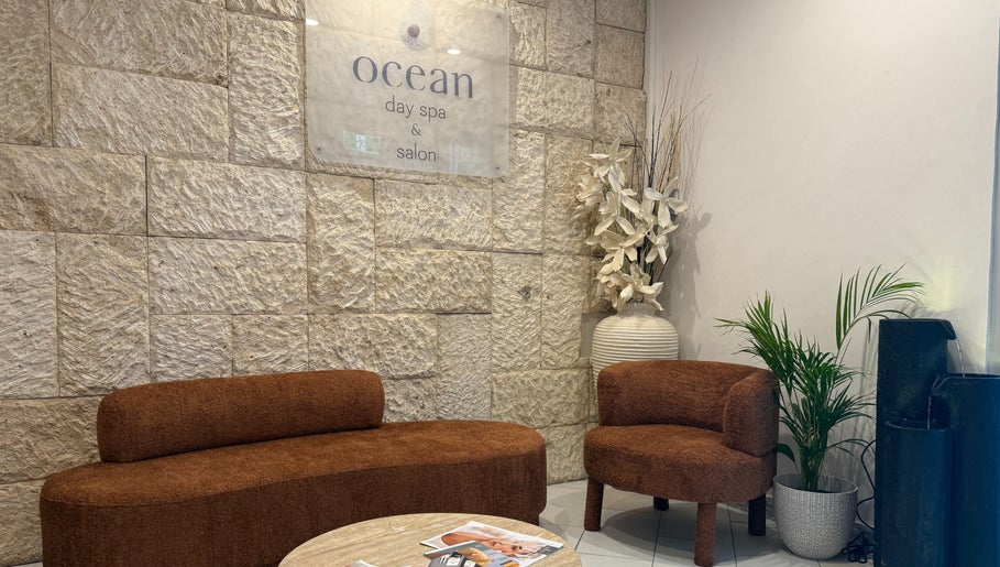 Cozy seating area at OCEAN Day Spa, Surfers Paradise, Queensland, AU with warm decor and relaxing ambiance.