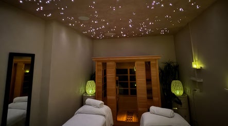 Tranquil therapy room at OCEAN Day Spa, Surfers Paradise, Queensland, AU, featuring a starlit ceiling and sauna.