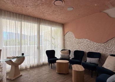 Relaxing lounge area at OCEAN Day Spa, Surfers Paradise, Queensland, AU. Cozy chairs and soft lighting.