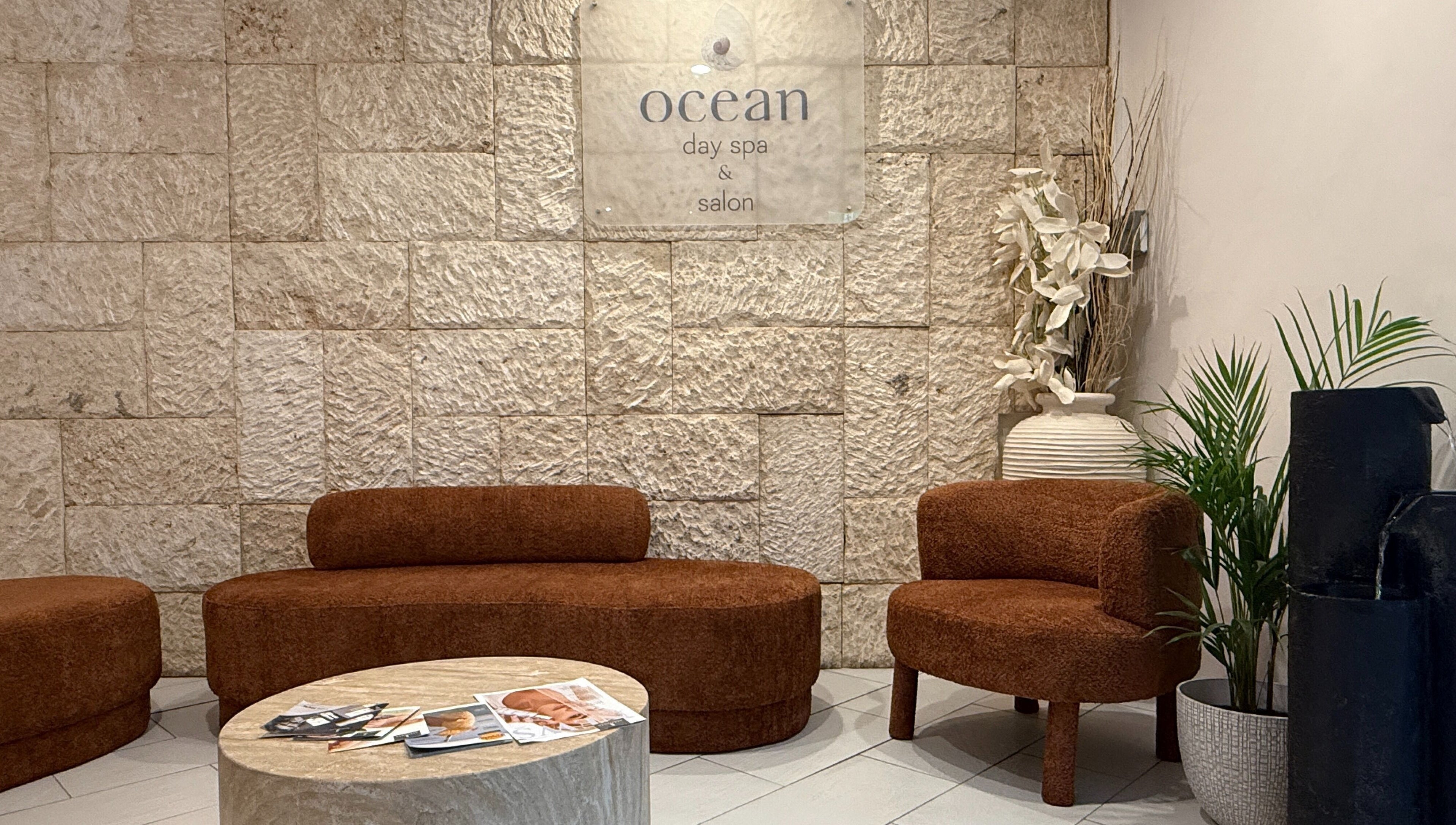 Relax in the welcoming lounge at OCEAN Day Spa, Surfers Paradise, Queensland, AU. Warm decor and comfortable seating.