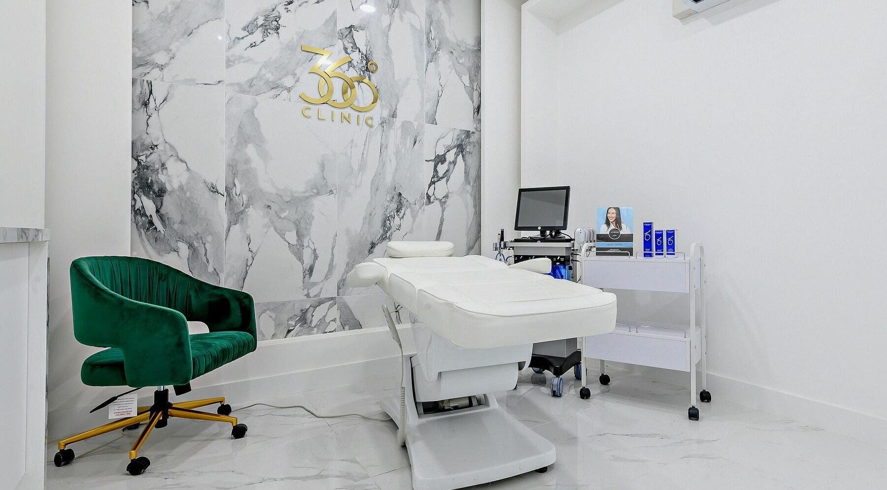 Elegant treatment room at 360 Degree Clinic, Surbiton, England, GB with marble walls and modern equipment.