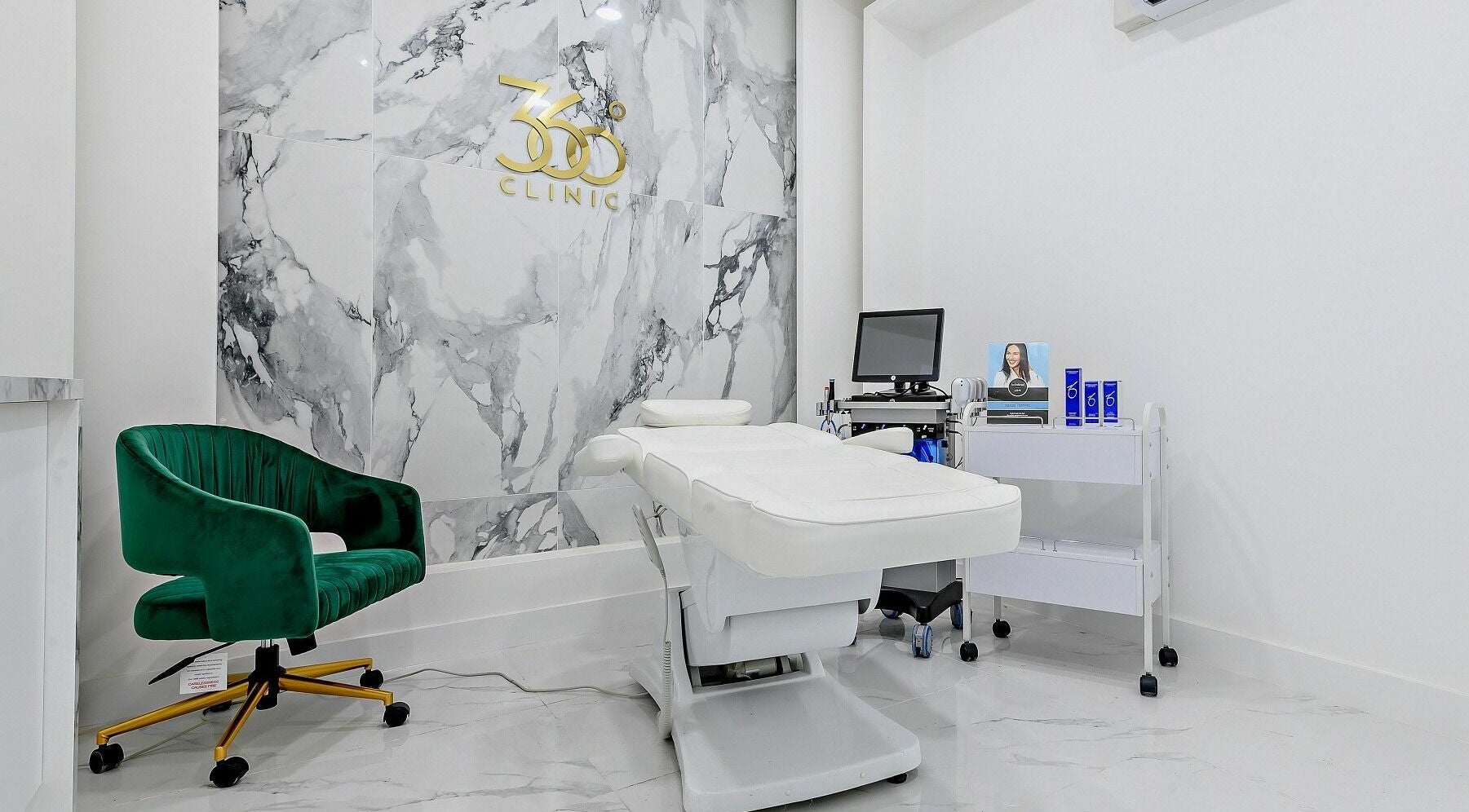 Elegant treatment room at 360 Degree Clinic, Surbiton, England, GB with marble walls and modern equipment.