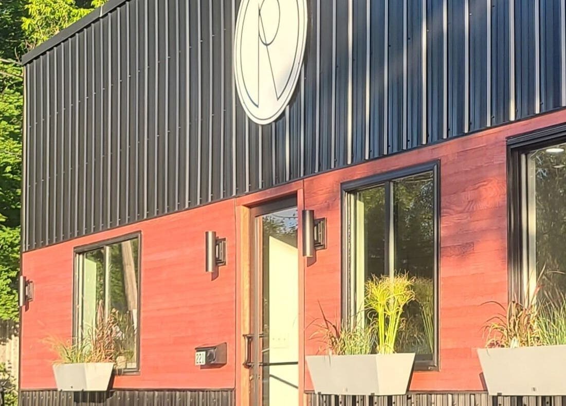 Exterior of Gemini Skin + Lash Studio in Winthrop, Maine, US with modern design and vibrant plant decor.