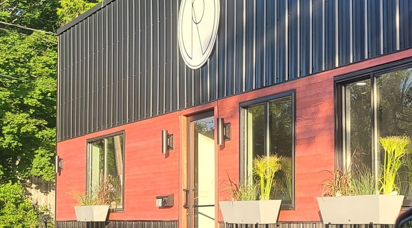 Exterior of Gemini Skin + Lash Studio in Winthrop, Maine, US with modern design and vibrant plant decor.