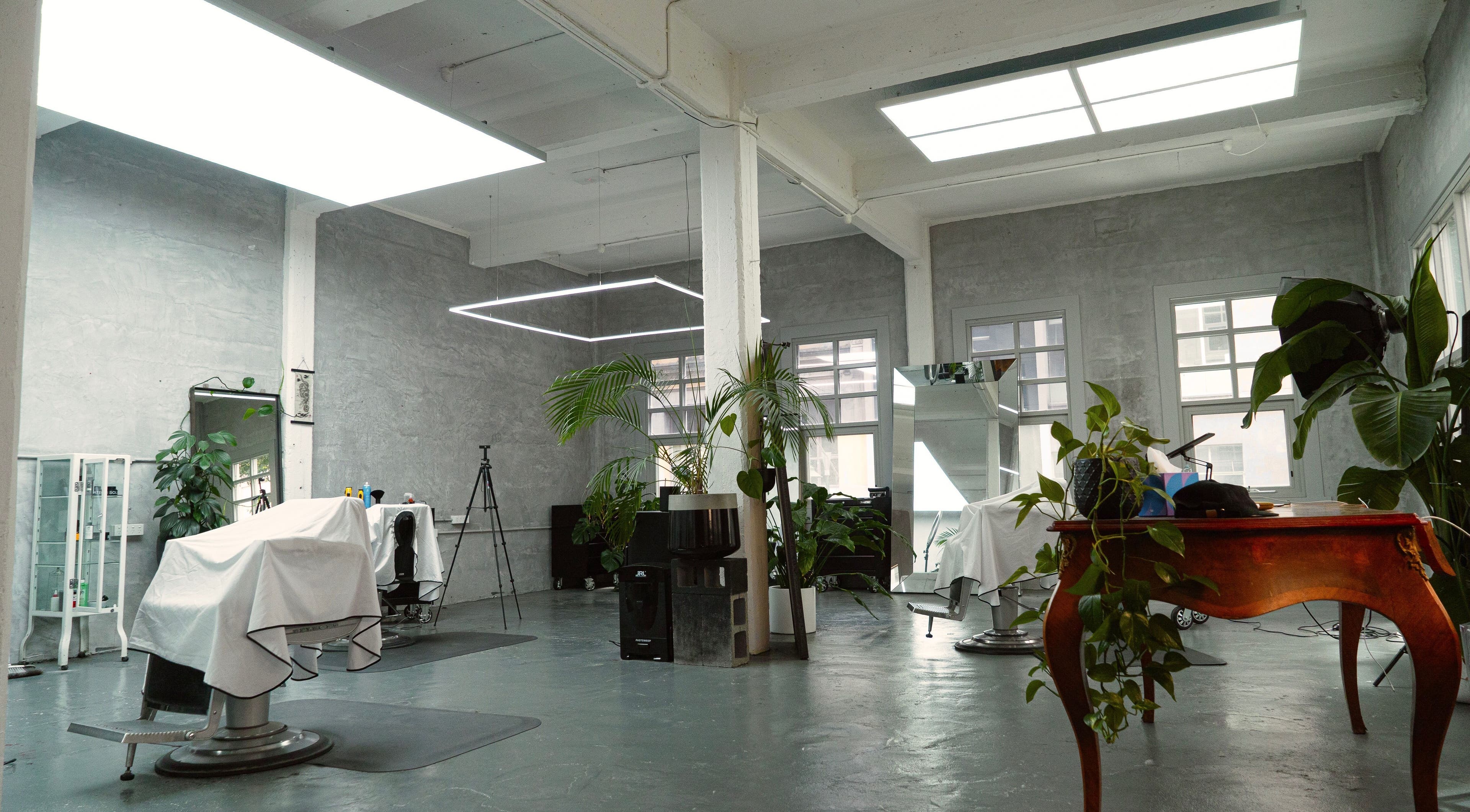Spacious, modern interior of Onyx Studio in Melbourne, Victoria, AU with stylish decor and lush greenery.